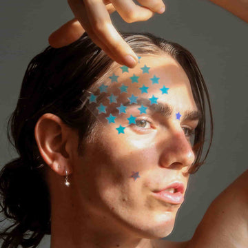 Boy wearing the holographic stars pimple patch