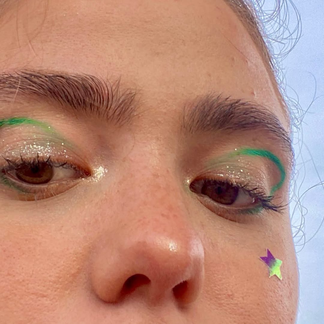 Girl wearing the holographic stars pimple patch with makeup