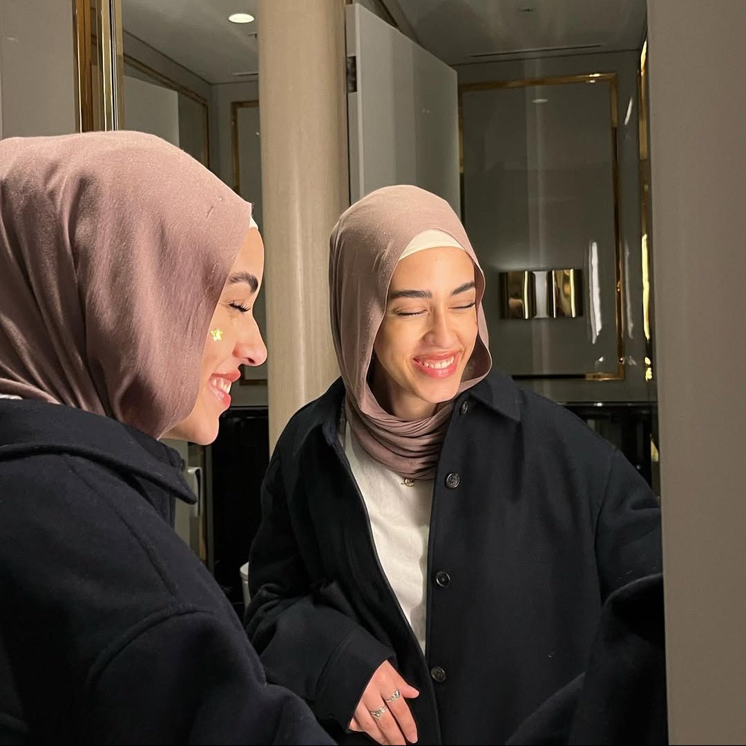 Girl wearing the Holographic Star Pimple Patch from Patch Project, smiling to the mirror